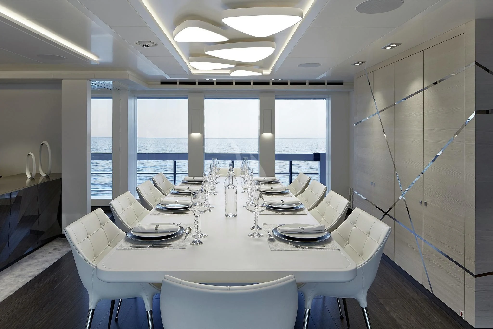 a large white dining table aboard HOME Yacht for Charter
