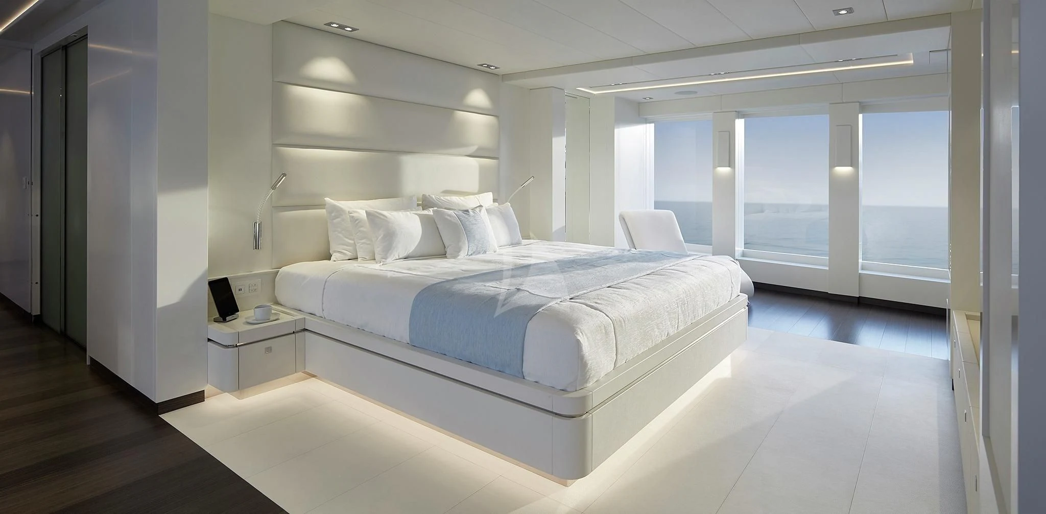 a large white bed in a room aboard HOME Yacht for Charter