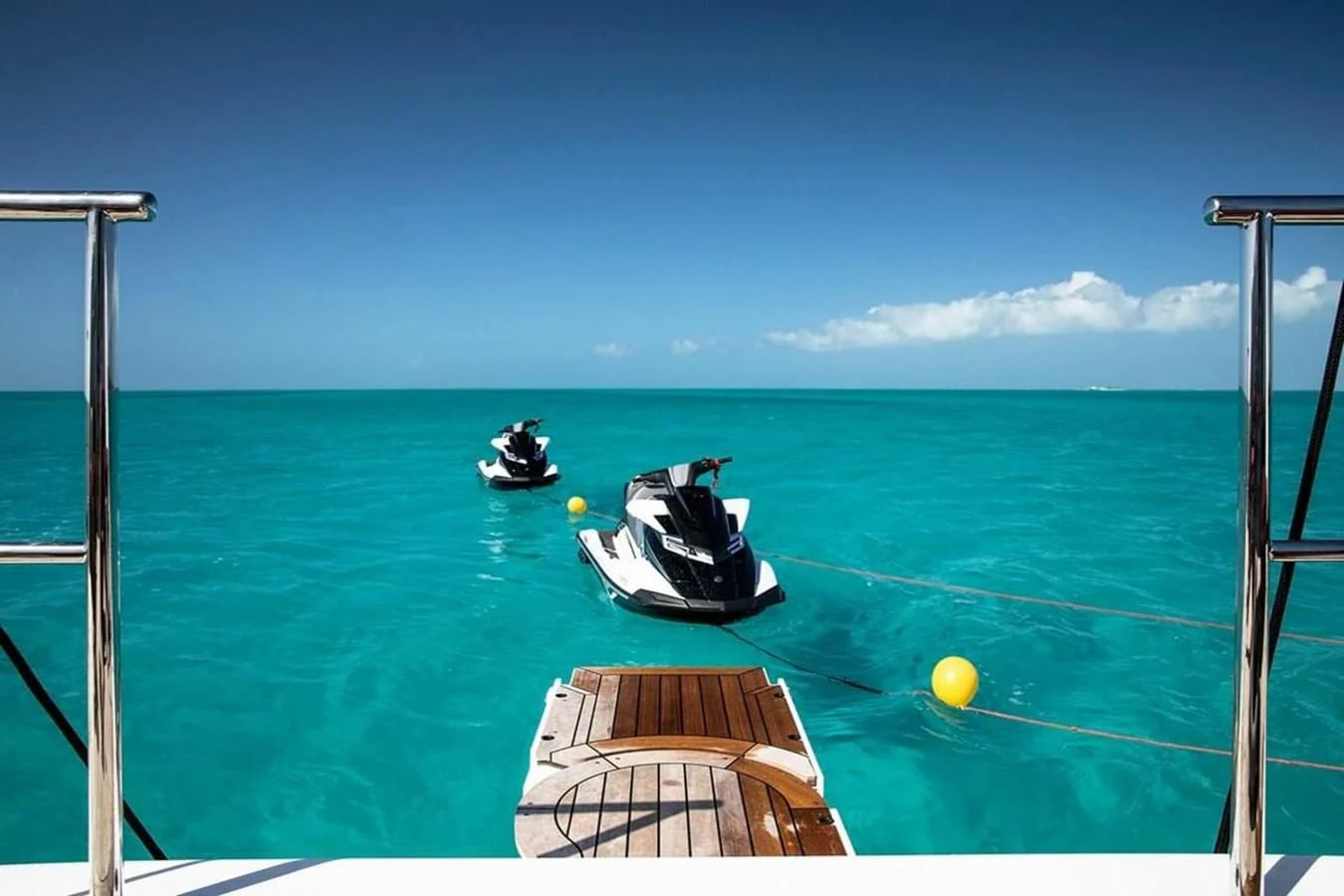 a couple of boats in the ocean aboard HOME Yacht for Charter