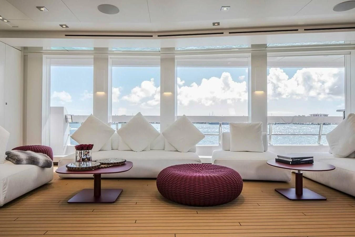 a living room with a large window aboard HOME Yacht for Charter