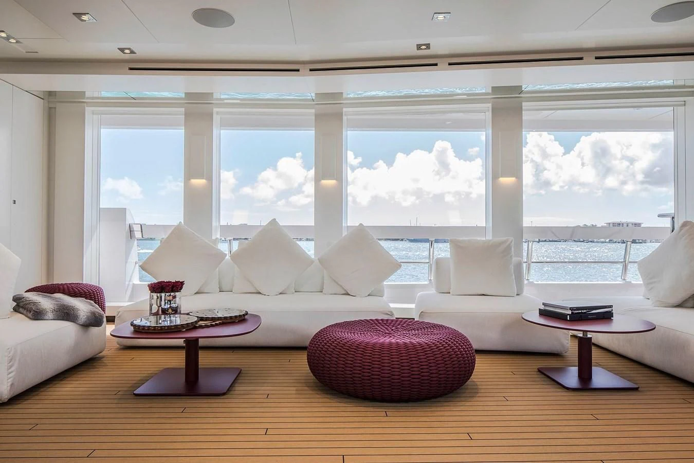 a living room with a large window aboard HOME Yacht for Charter