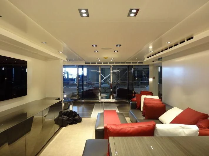a room with a couch and a tv aboard HOME Yacht for Charter