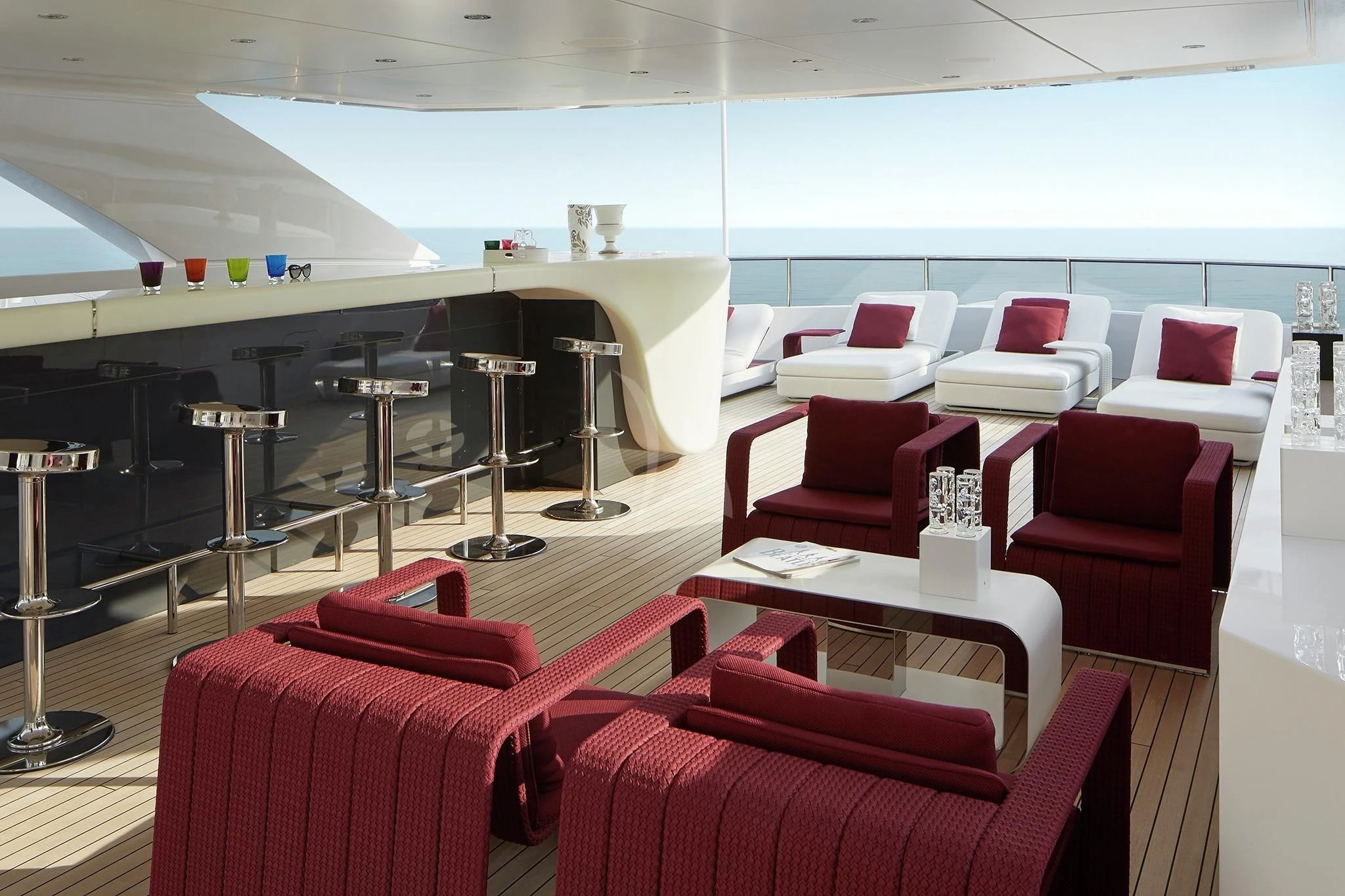a room with chairs and tables aboard HOME Yacht for Charter