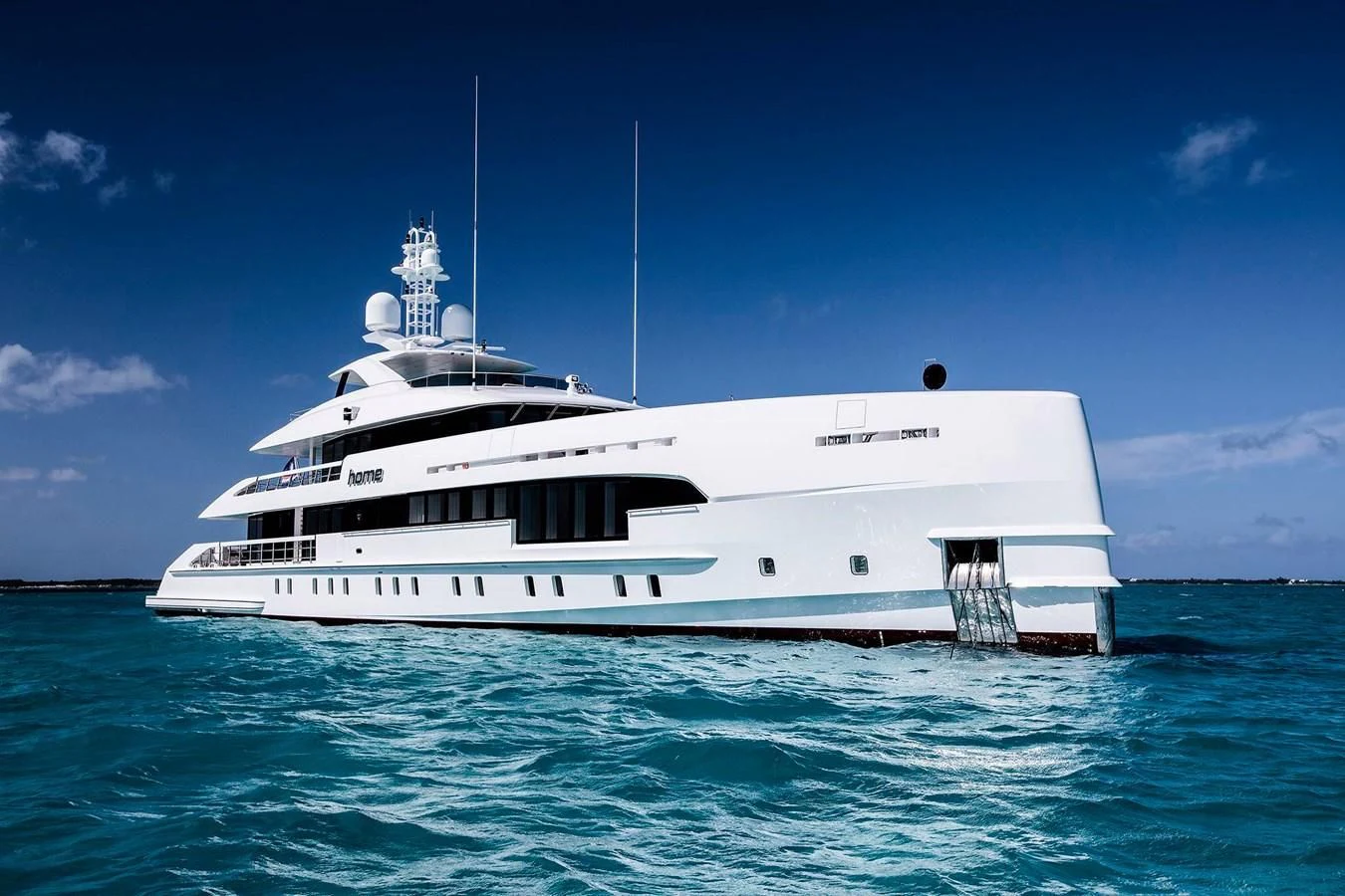 a white boat in the water aboard HOME Yacht for Charter