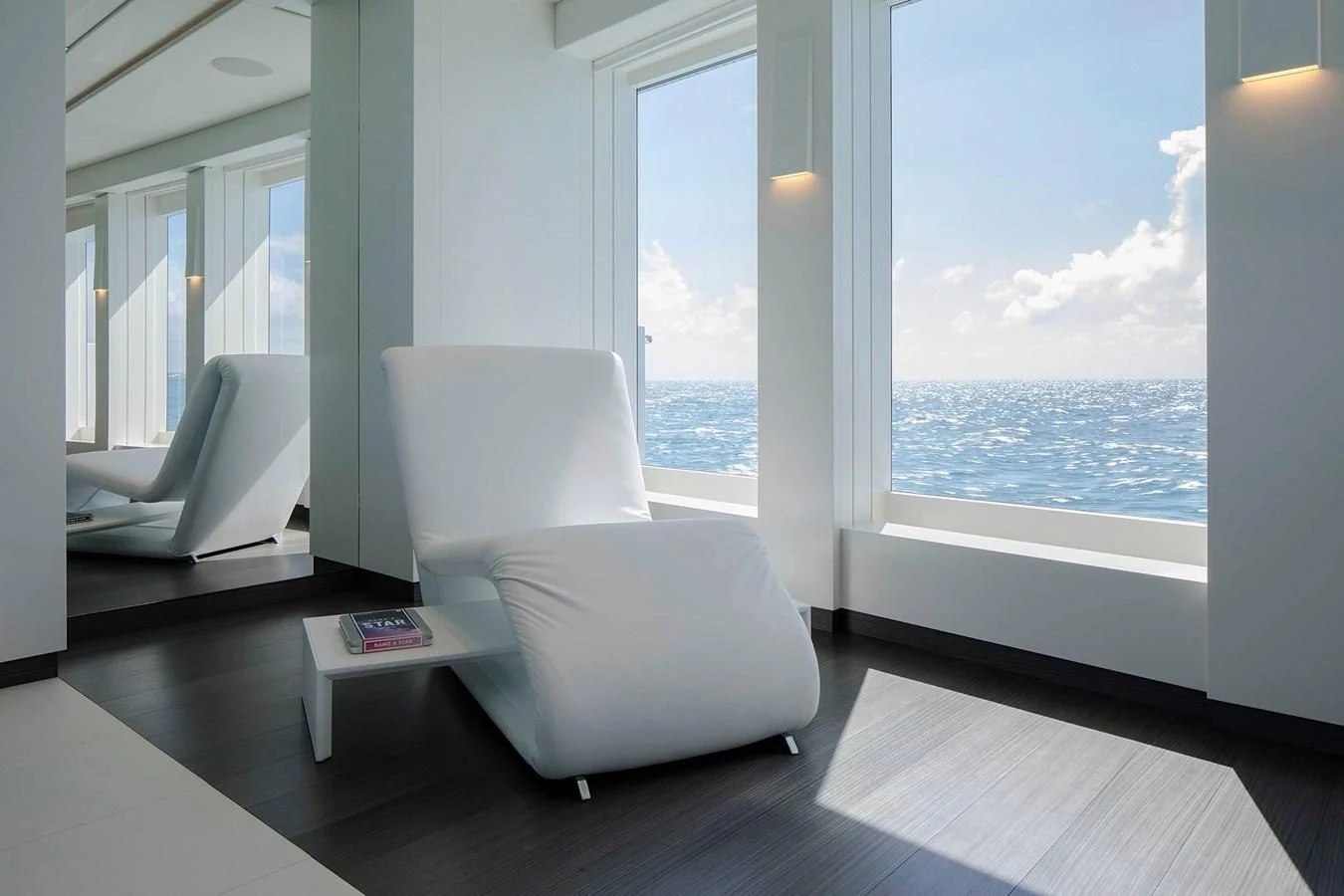 a white chair in a room aboard HOME Yacht for Charter