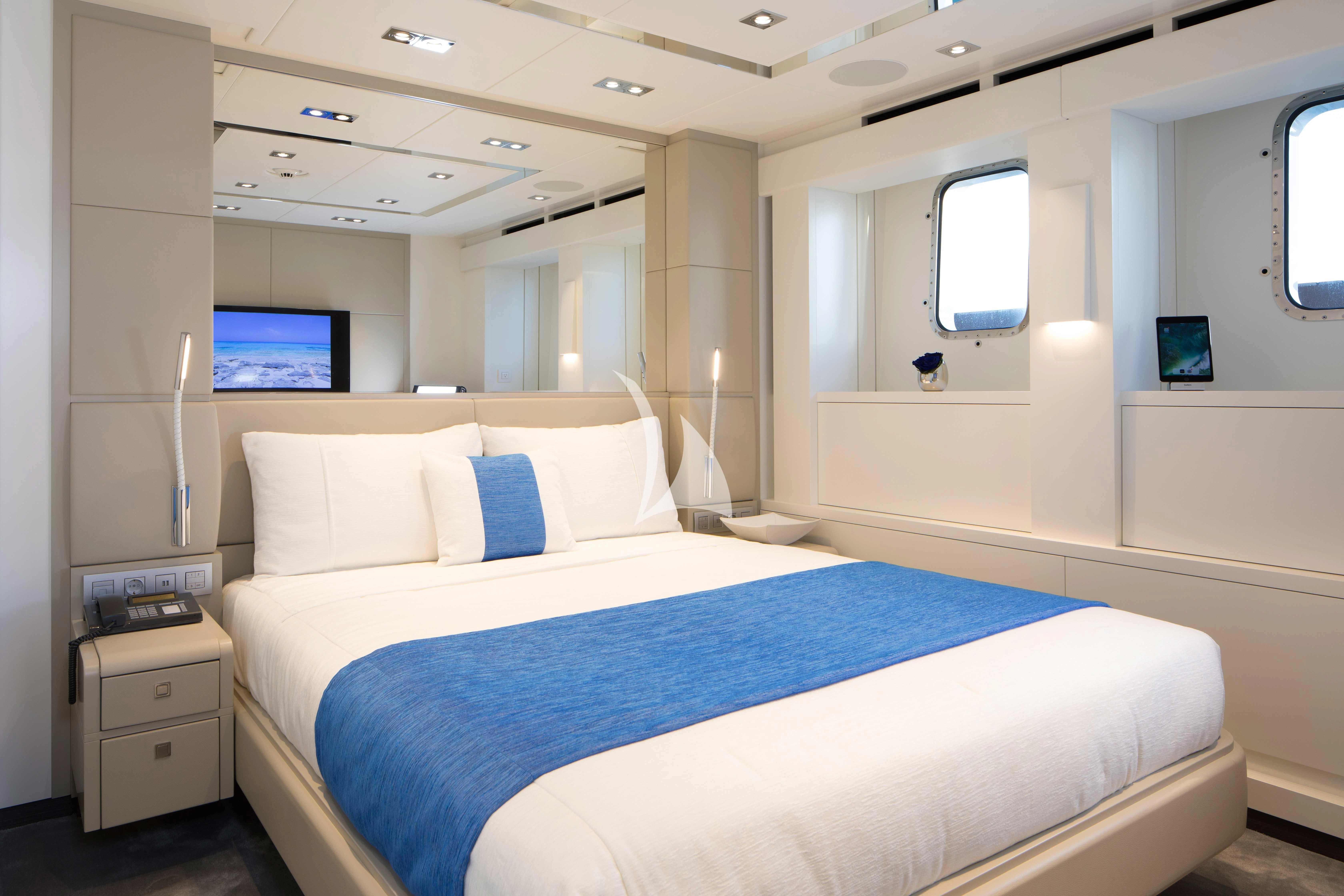 a room with two beds aboard HOME Yacht for Charter