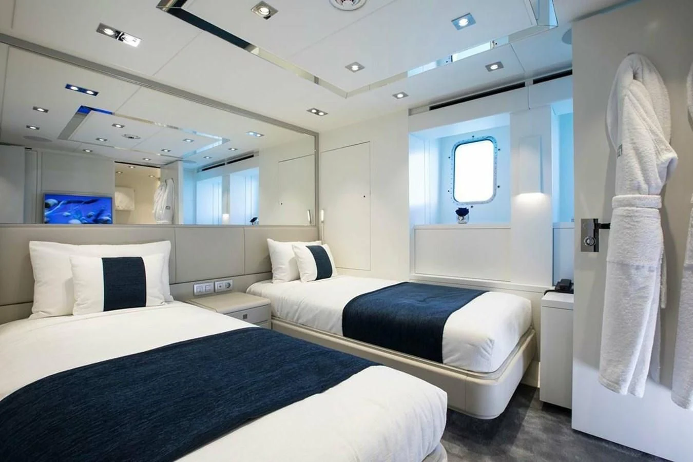a room with a couple of beds aboard HOME Yacht for Charter