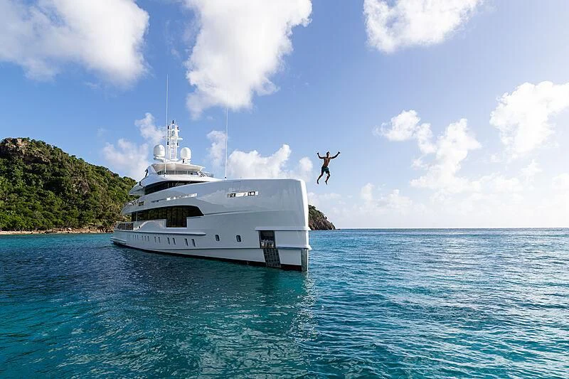 a person jumping off a boat aboard HOME Yacht for Charter