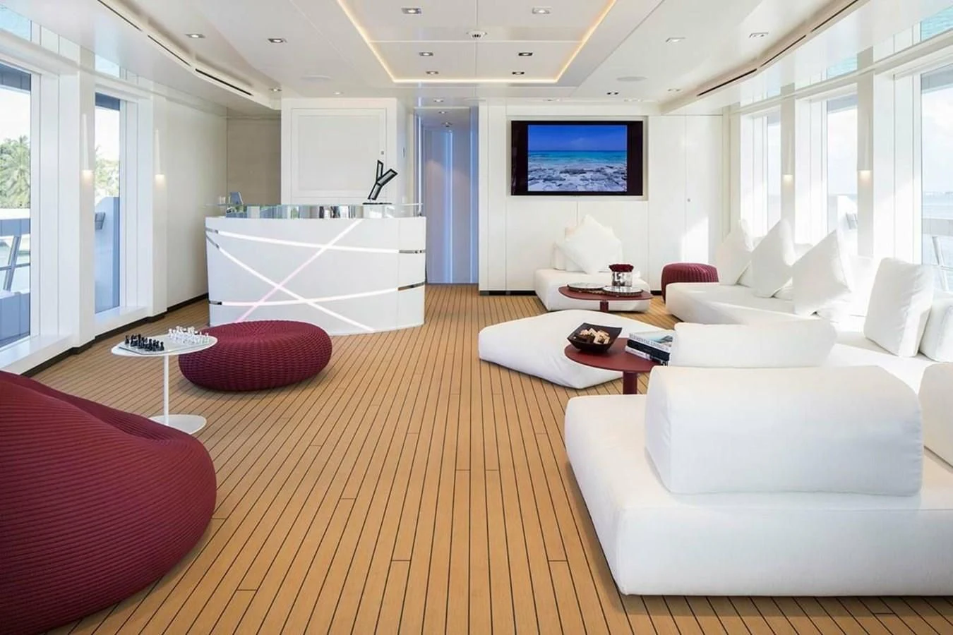 a living room with a large screen aboard HOME Yacht for Charter