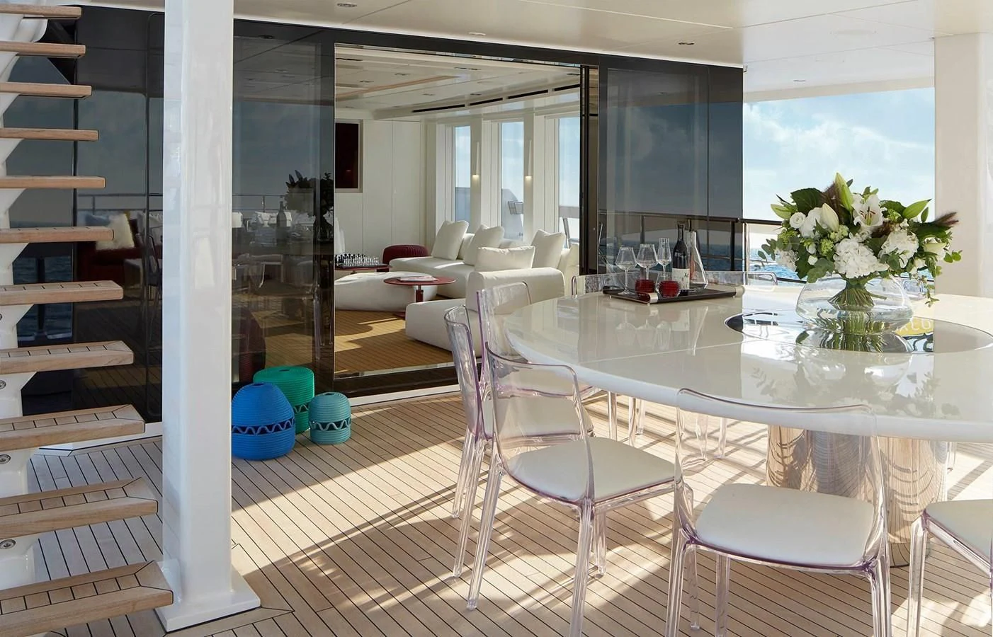 a room with a table chairs and a window aboard HOME Yacht for Charter