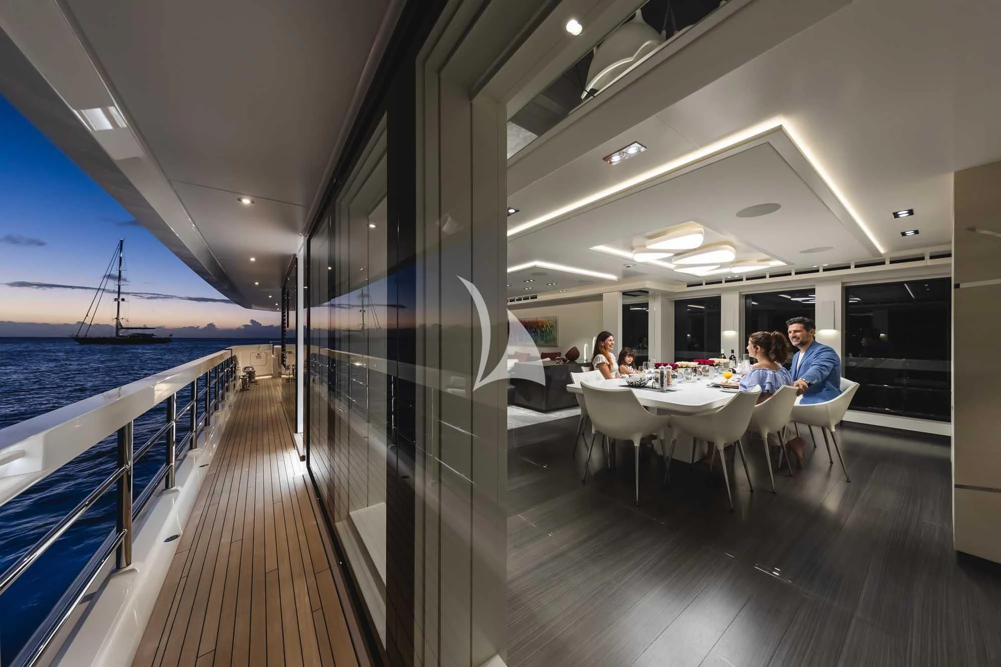 people sitting at tables on a boat aboard HOME Yacht for Charter