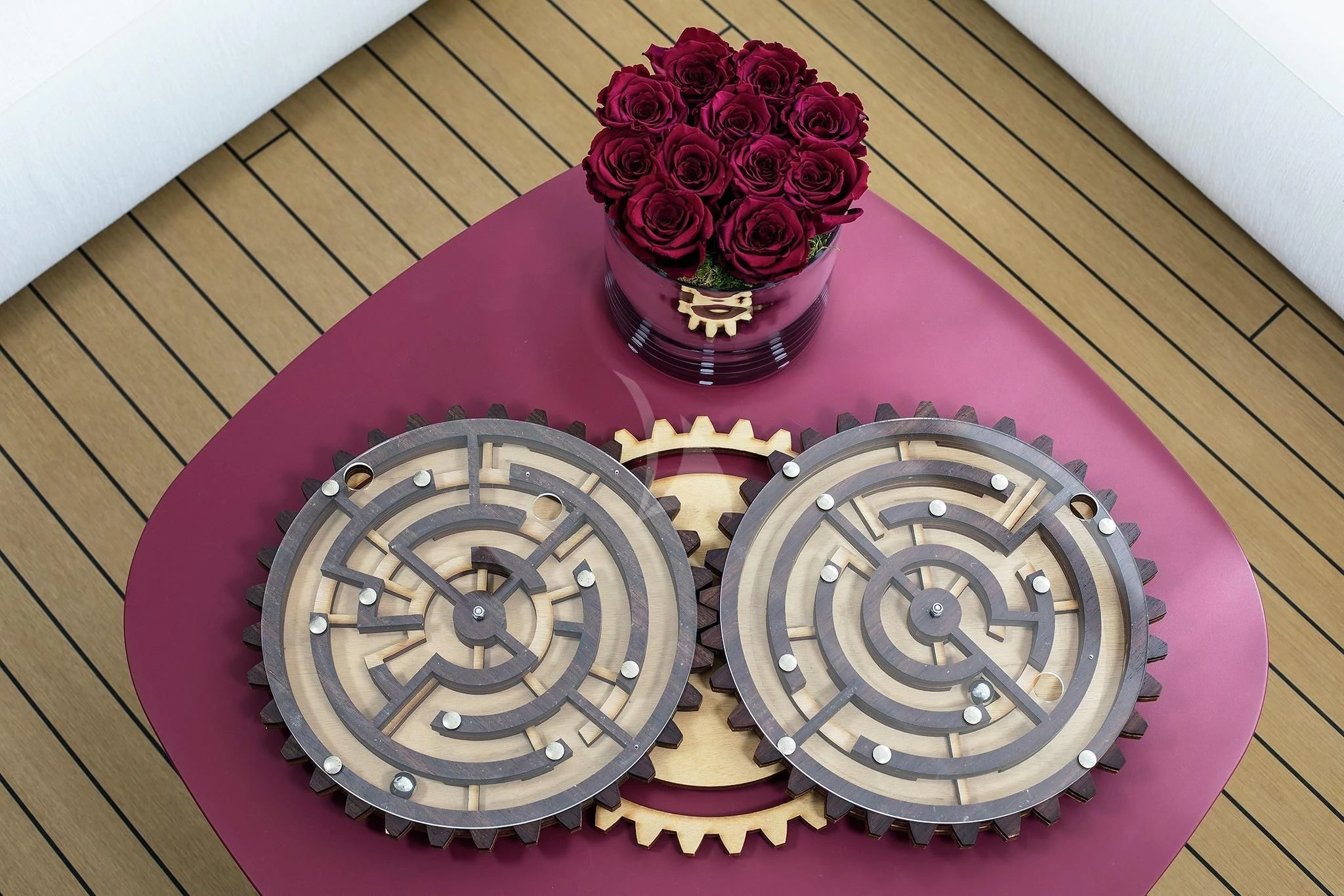 a red table with a red table cloth and a red flower aboard HOME Yacht for Charter