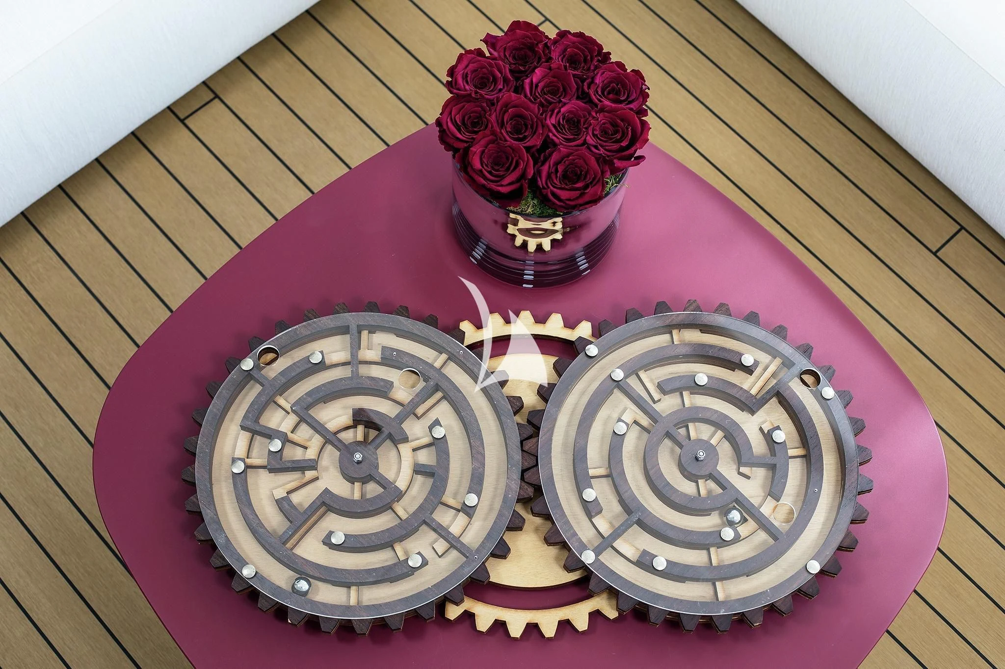 a red table with a red table cloth with a red flower and a white wall and a white aboard HOME Yacht for Charter