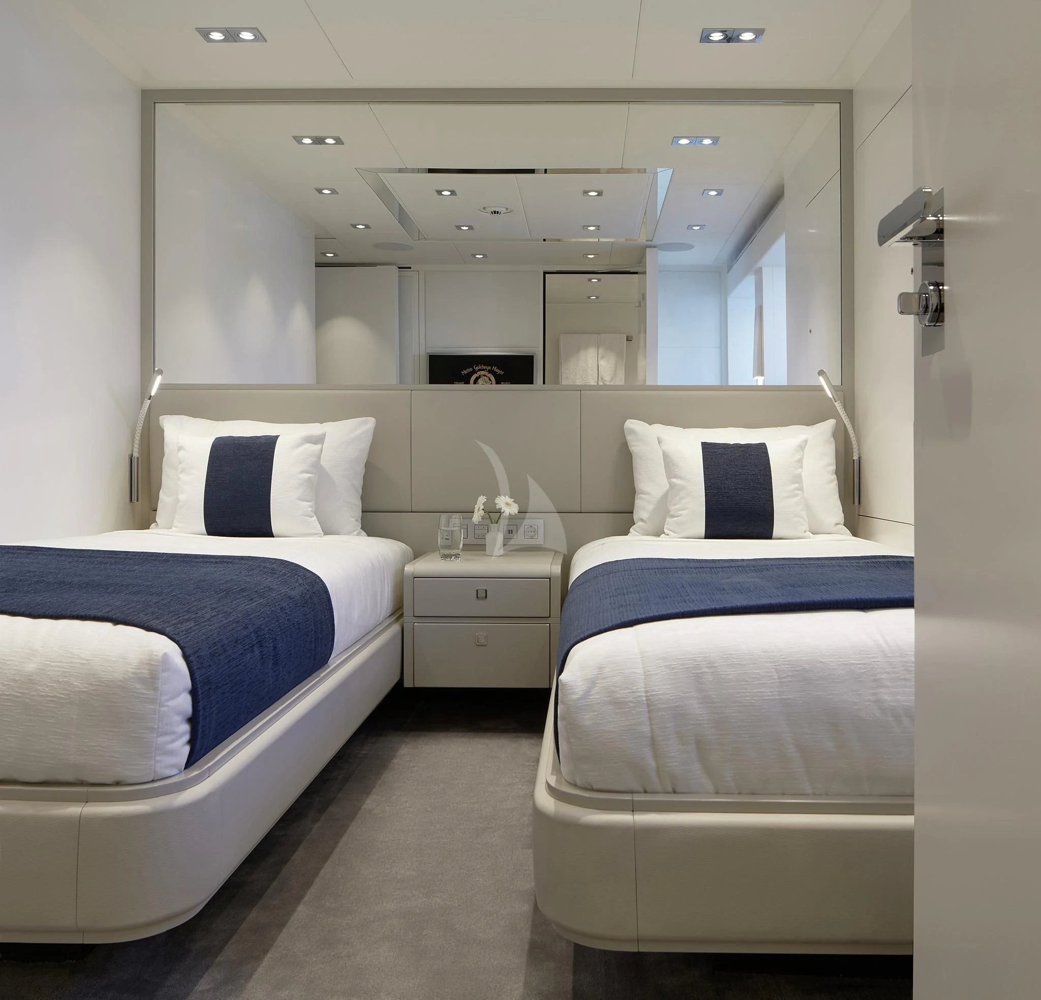 a room with white beds aboard HOME Yacht for Charter