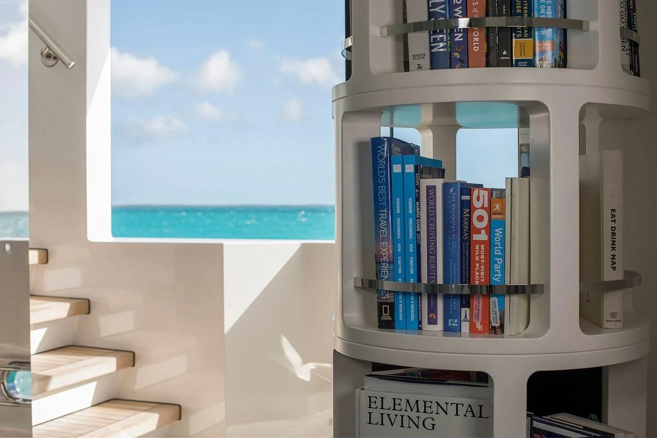 a computer tower with a group of books on it aboard HOME Yacht for Charter