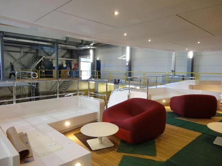 a large room with tables and chairs aboard HOME Yacht for Charter