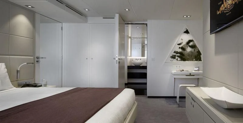 a room with a bed and a tv aboard HOME Yacht for Charter