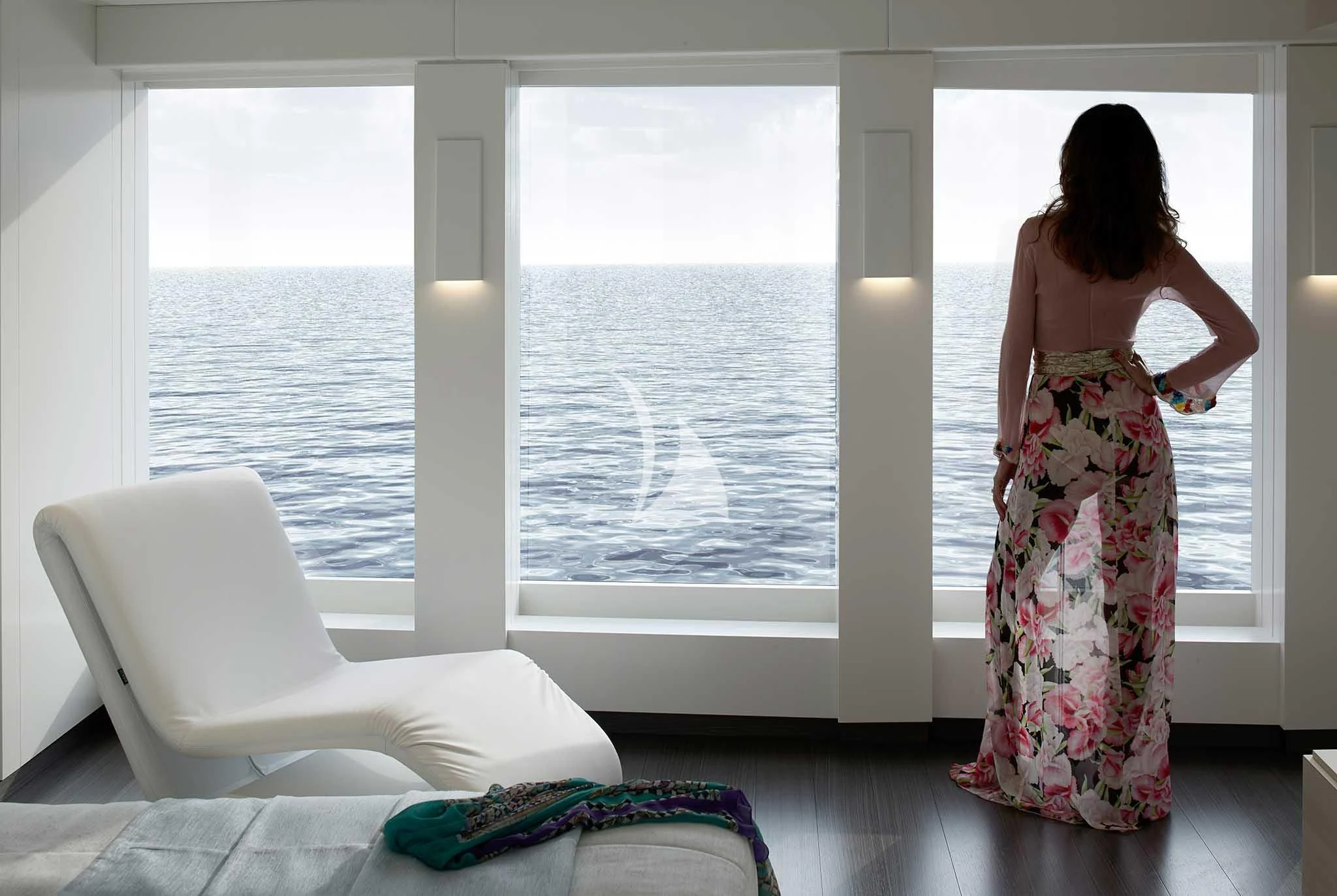 a person looking out a window aboard HOME Yacht for Charter