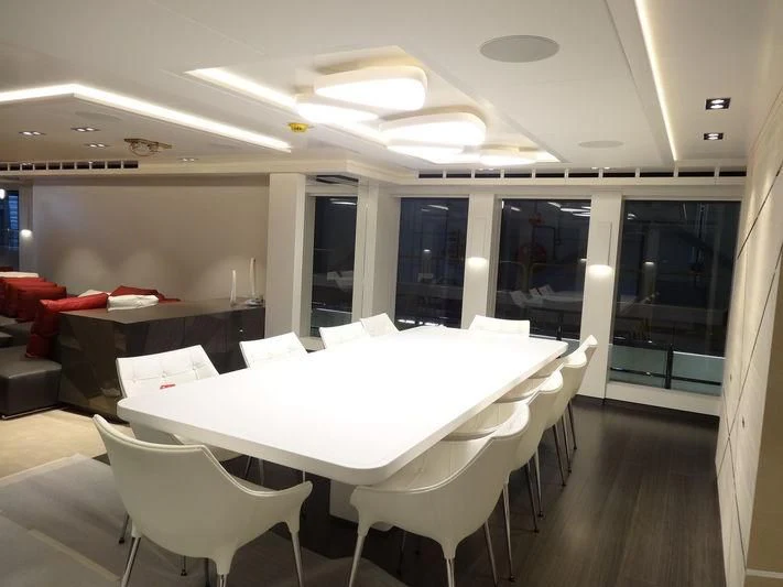 a conference room with a table and chairs aboard HOME Yacht for Charter
