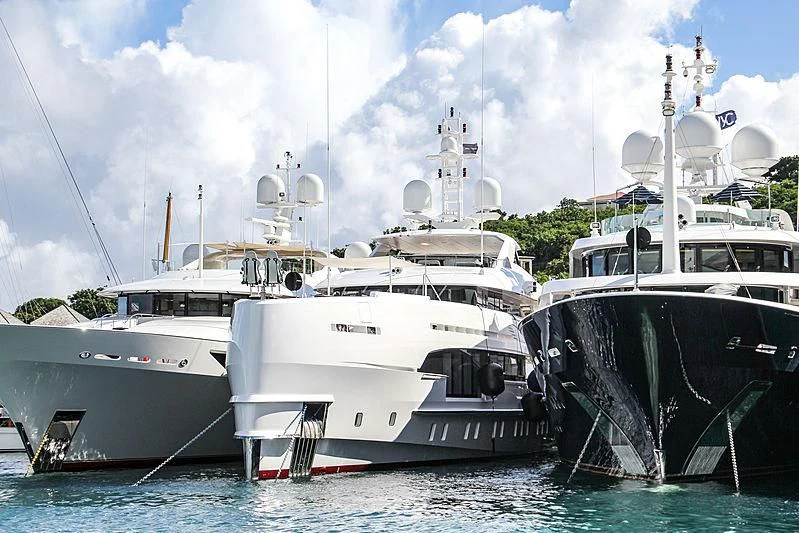 several boats docked at a pier aboard HOME Yacht for Charter