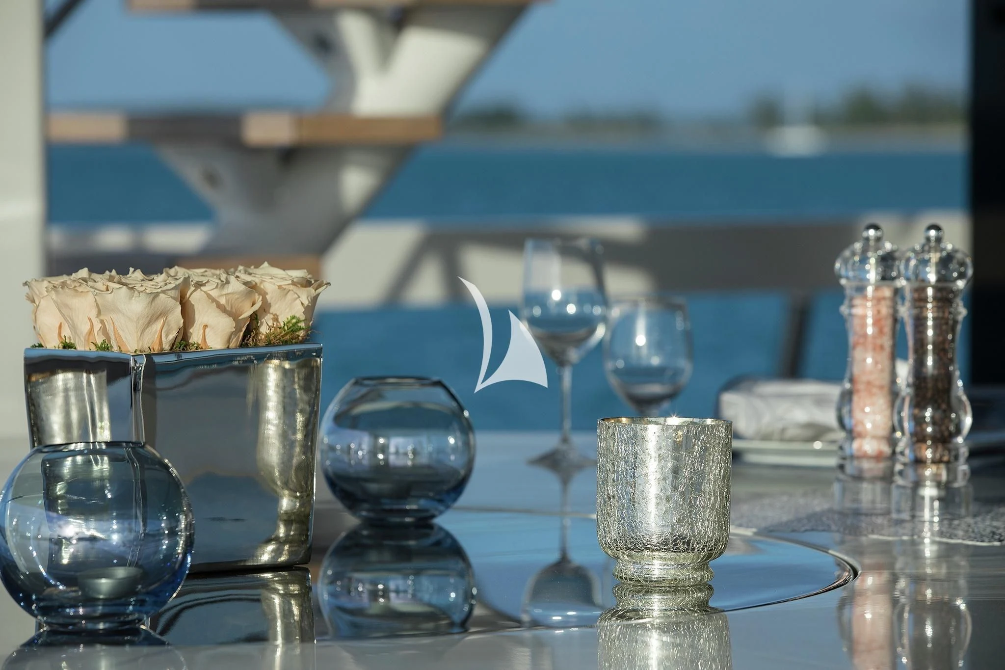 a table with glasses and food on it aboard HOME Yacht for Charter