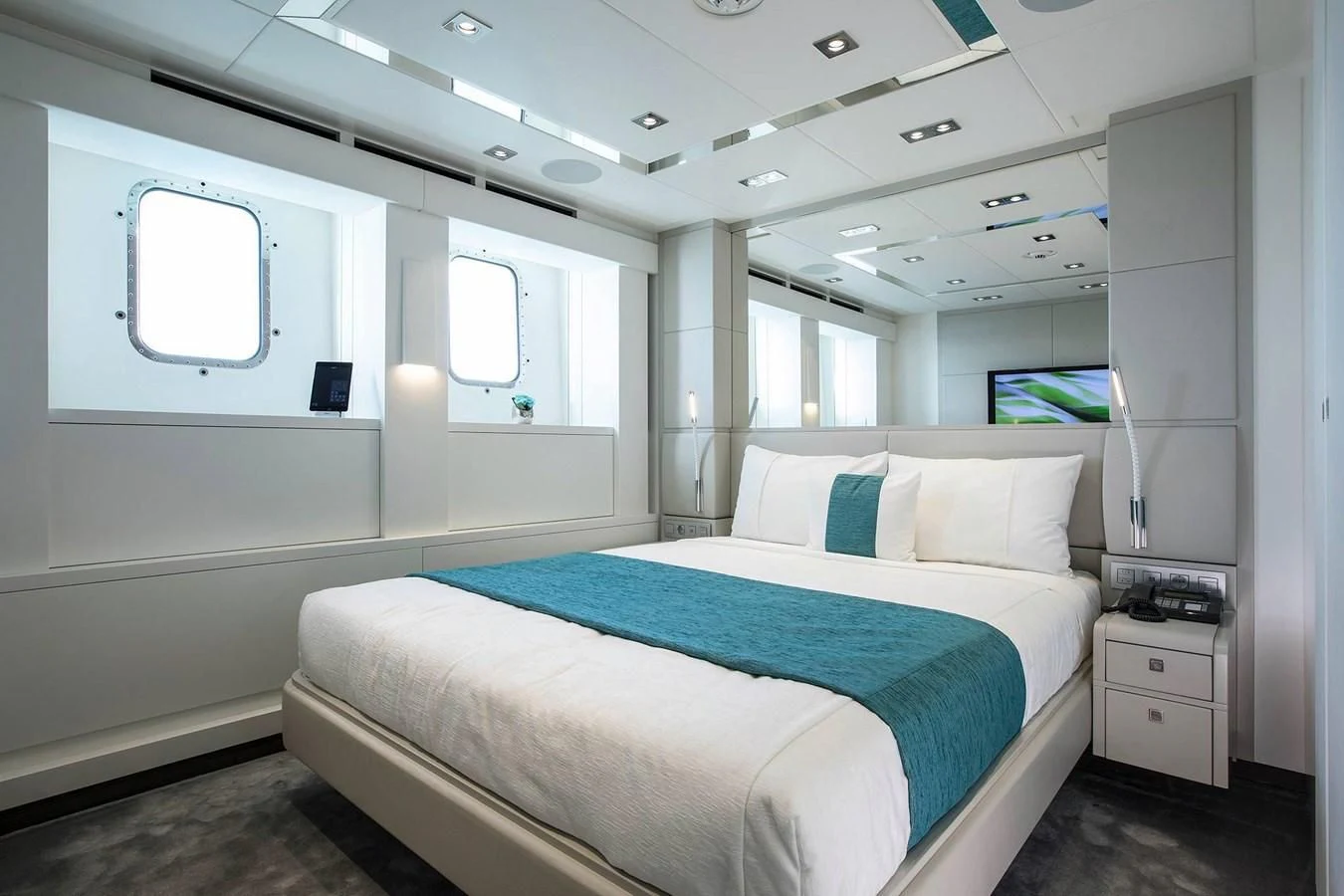 a room with a bed and a window aboard HOME Yacht for Charter