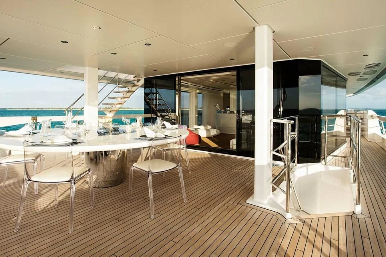 a room with tables and chairs aboard HOME Yacht for Charter