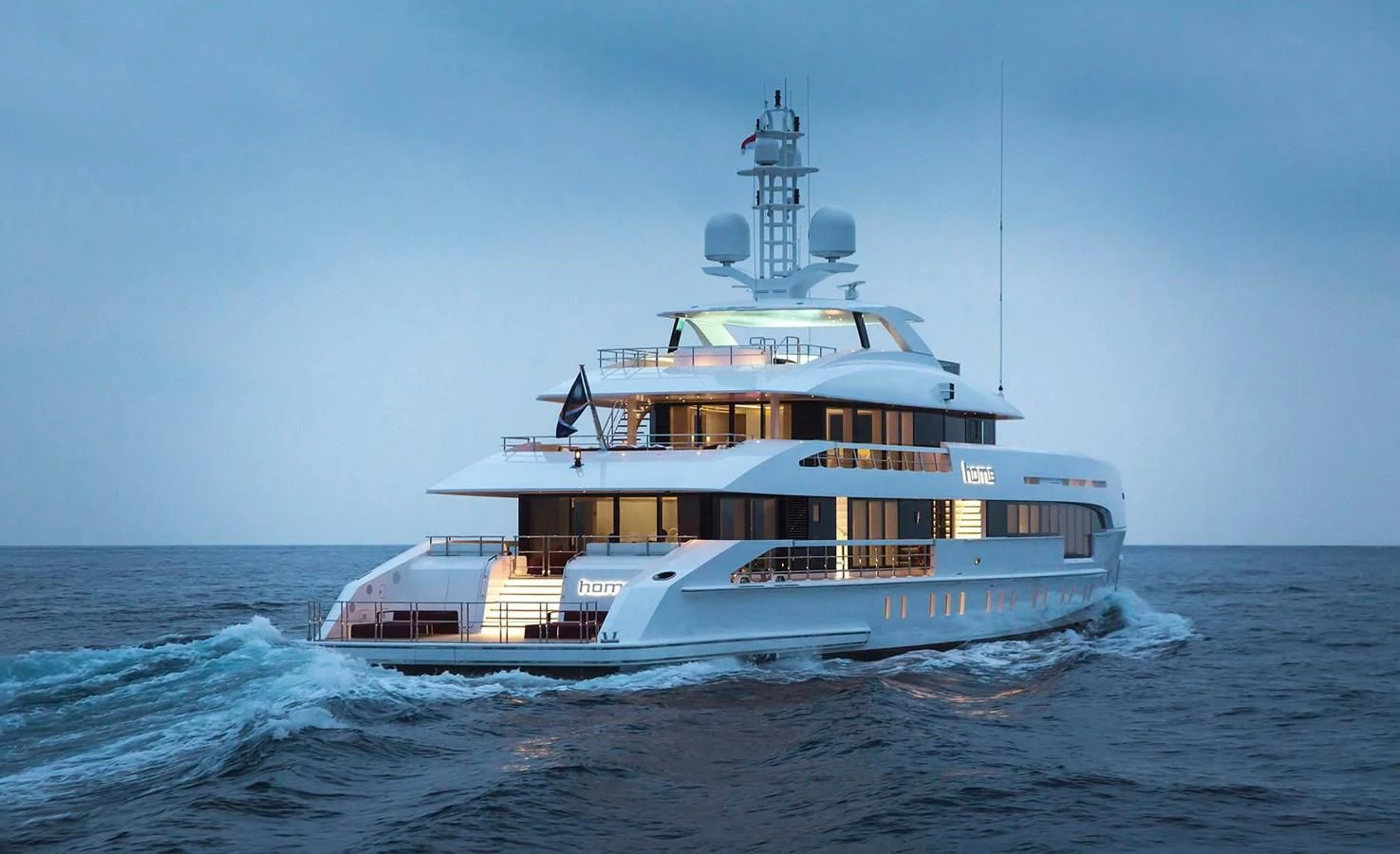 a large boat in the water with Thomas Point Shoal Light in the background aboard HOME Yacht for Charter