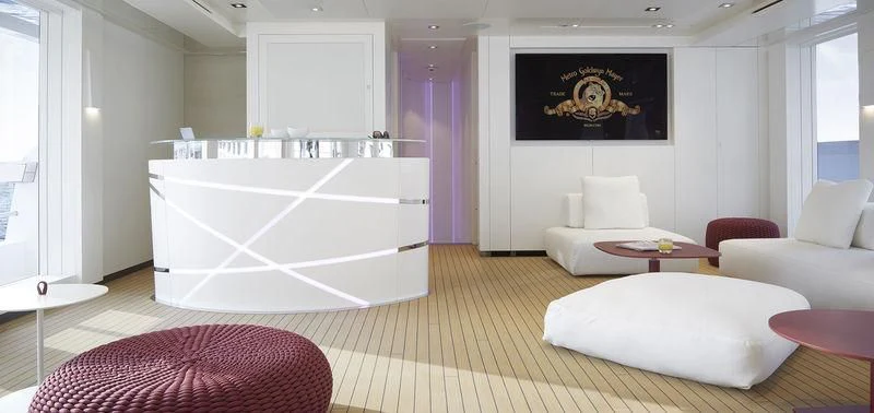 a large white bathtub in a room with a couch and a rug aboard HOME Yacht for Charter