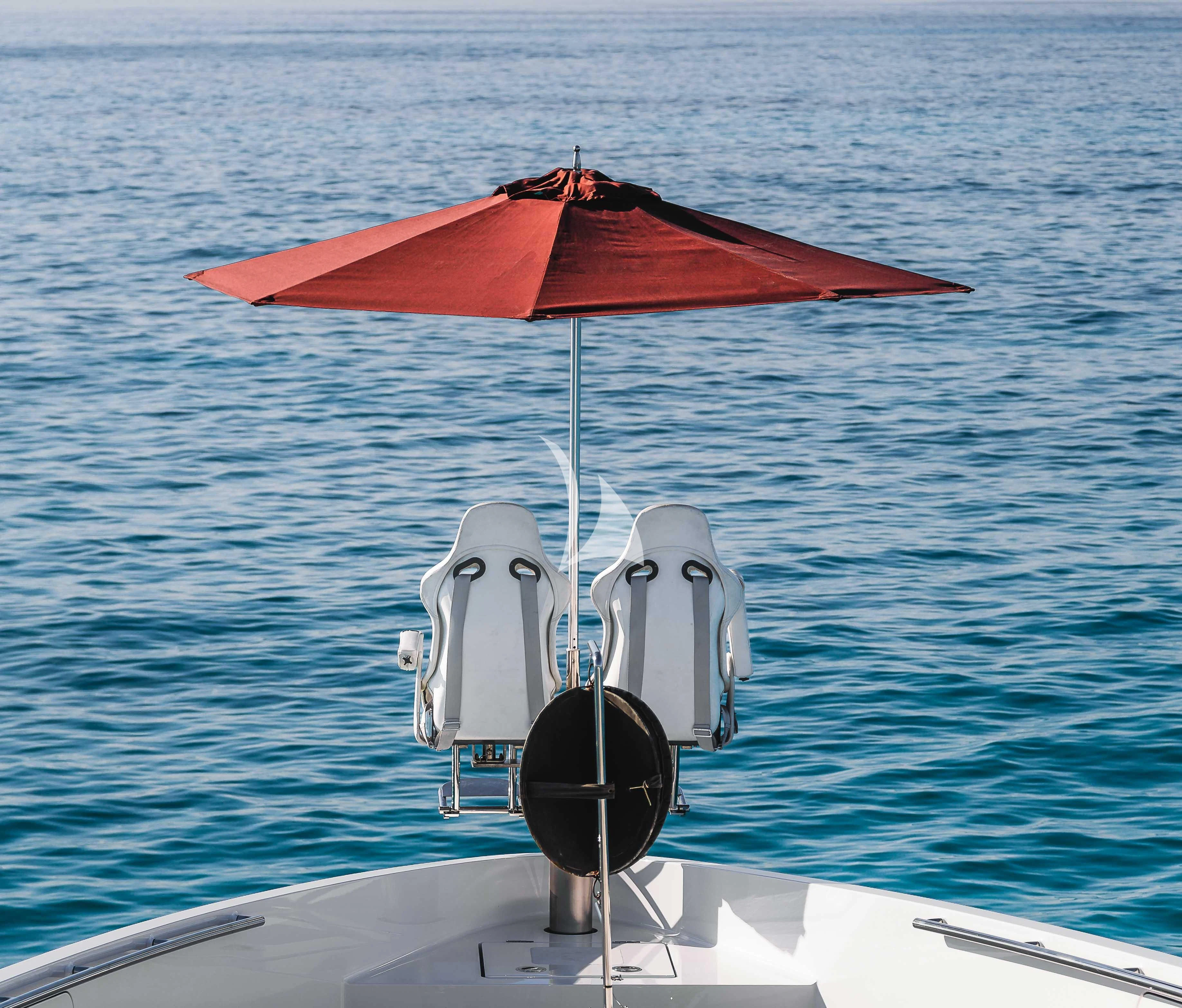 a boat with an umbrella aboard HOME Yacht for Charter