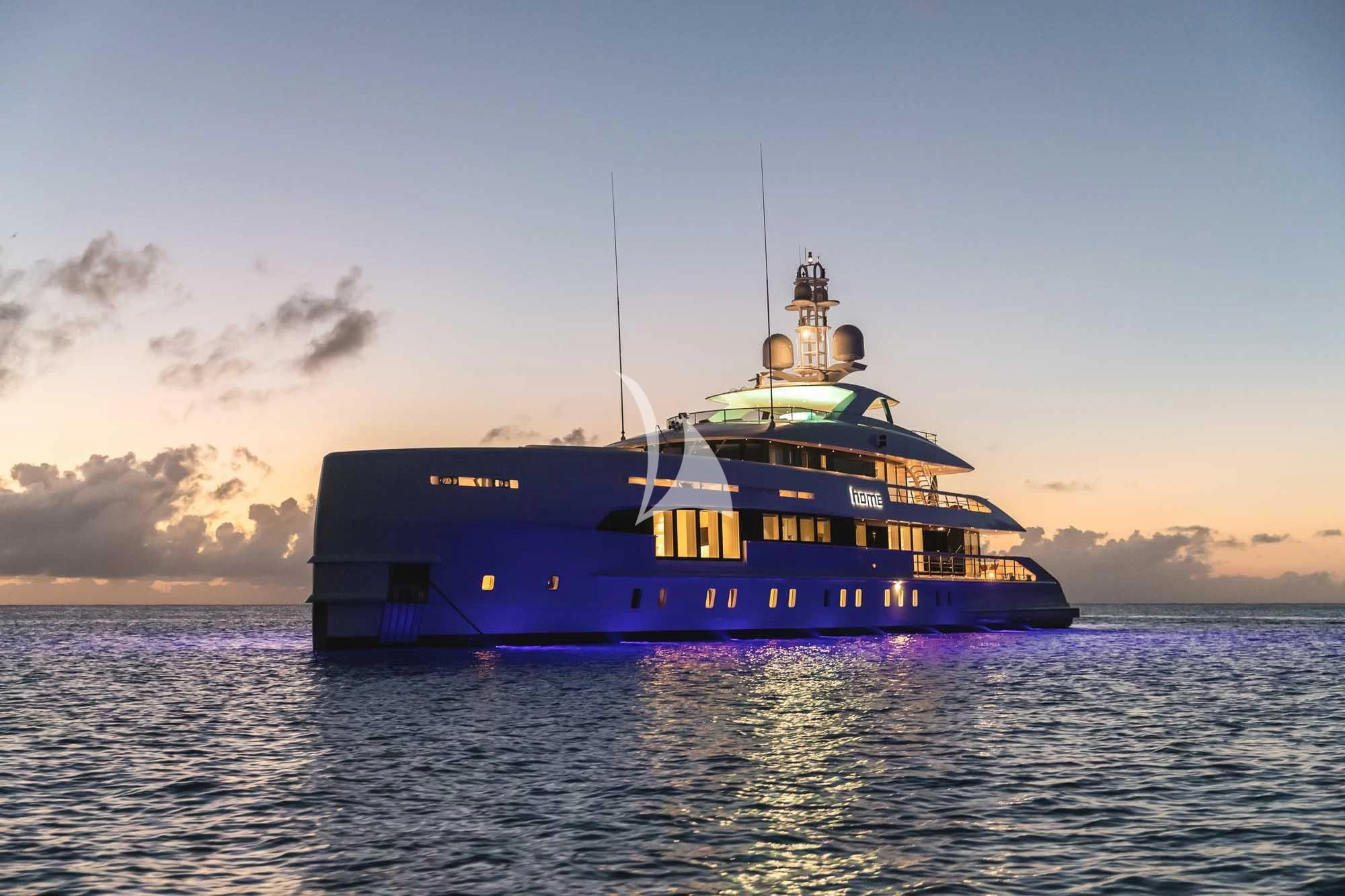 a large blue and yellow boat in the water aboard HOME Yacht for Charter