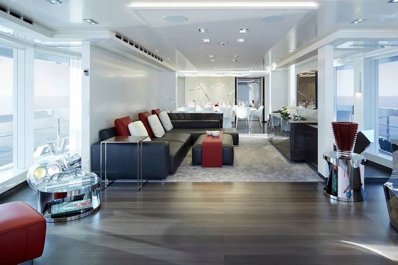 a living room with a wood floor aboard HOME Yacht for Charter