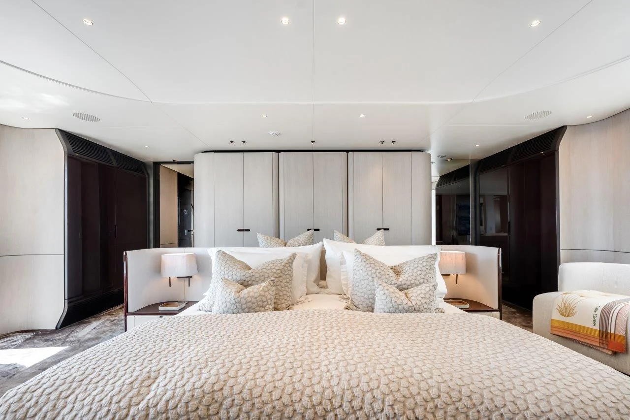 a large bed with white sheets aboard ECLIPSE Yacht for Sale