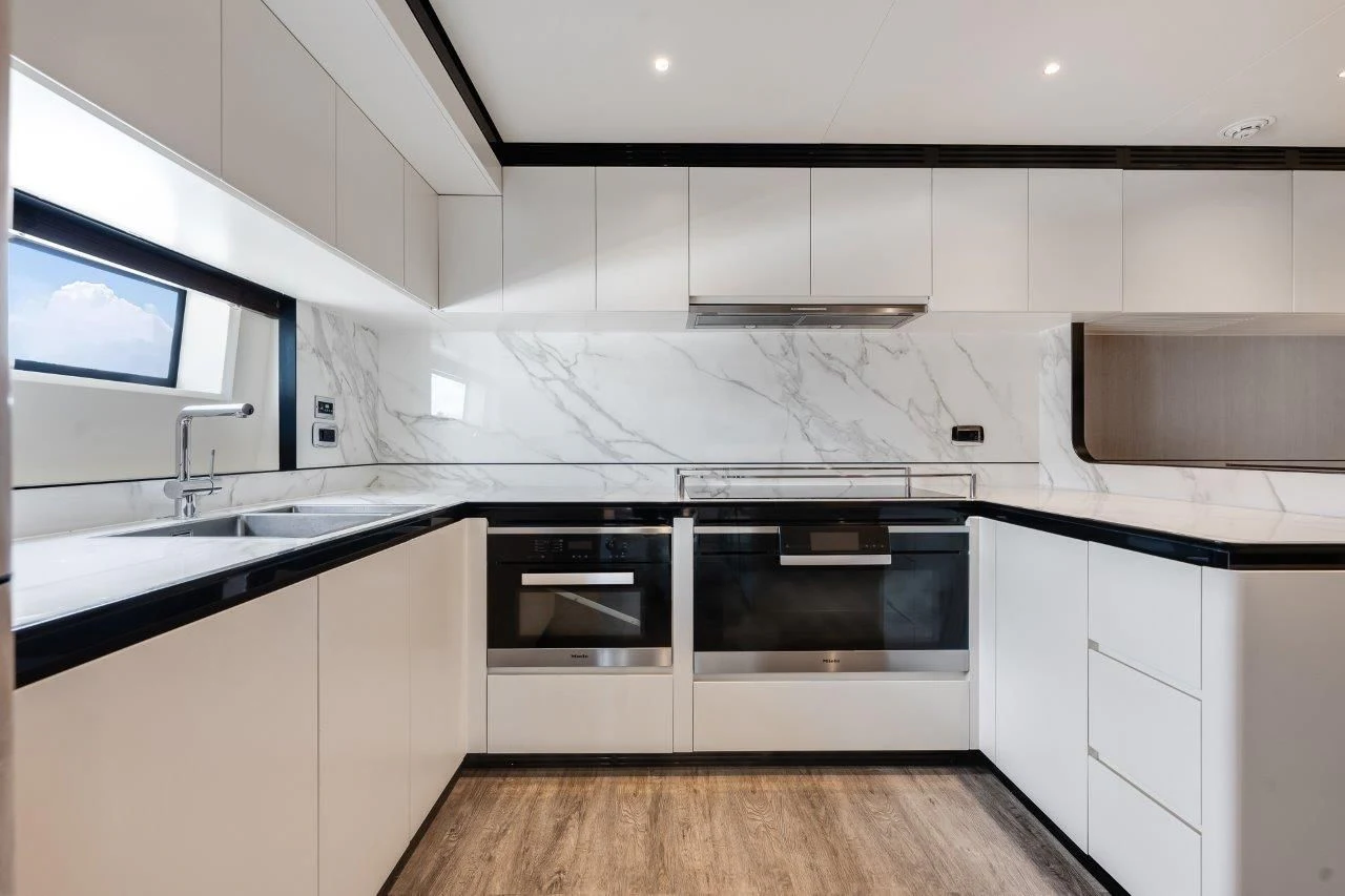 a kitchen with white cabinets aboard ECLIPSE Yacht for Sale