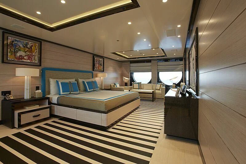 a room with a bed and a desk aboard MADAME KATE Yacht for Sale