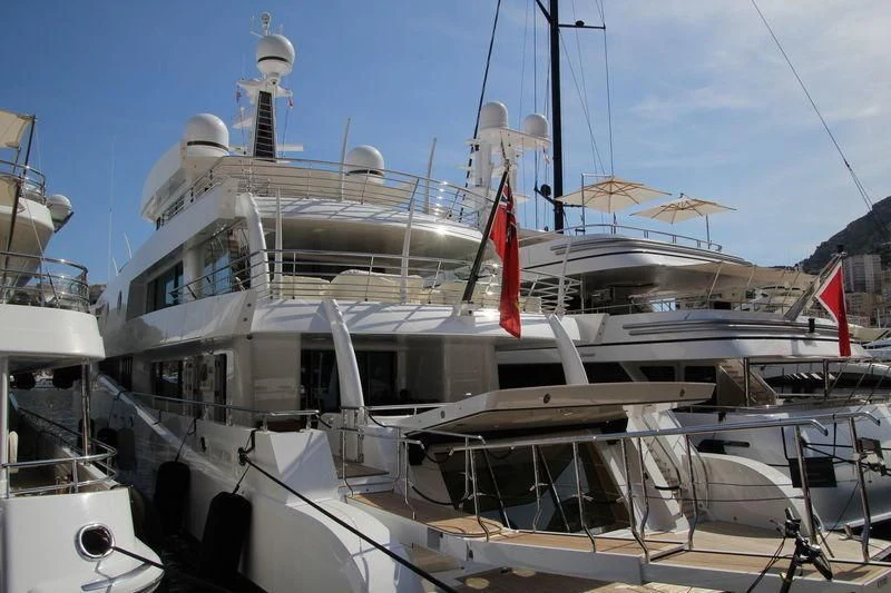 a large white boat with a red flag on it aboard MADAME KATE Yacht for Sale