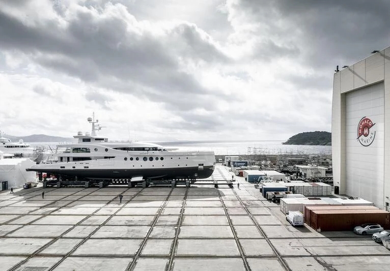 a large white ship in a harbor aboard MADAME KATE Yacht for Sale