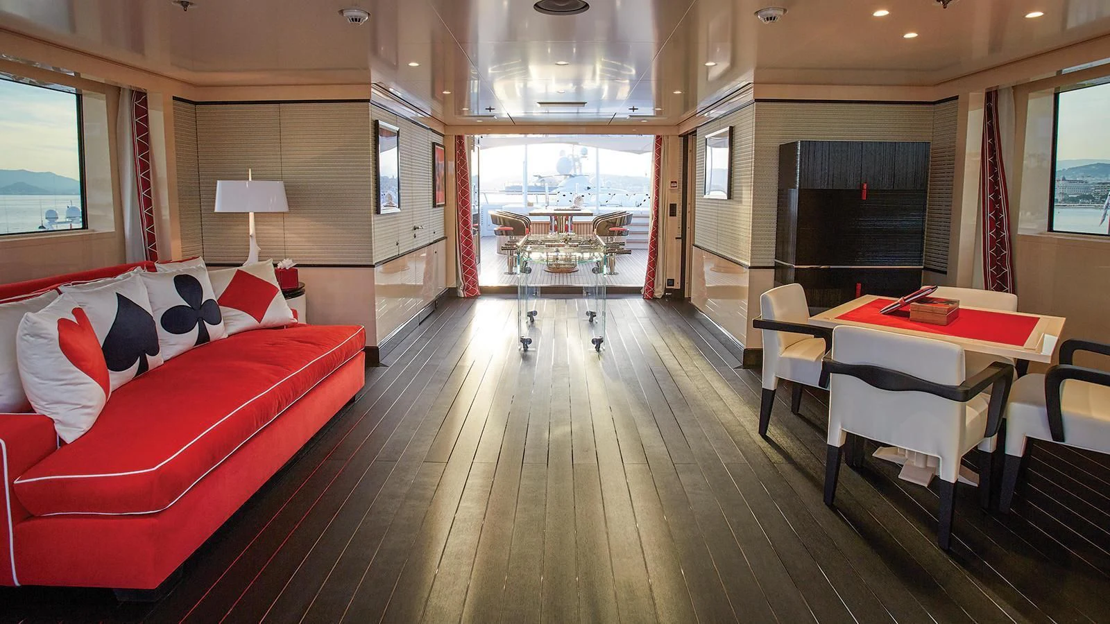 a living room with a table and couches aboard MADAME KATE Yacht for Sale