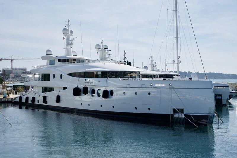 a large white boat in a harbor aboard MADAME KATE Yacht for Sale