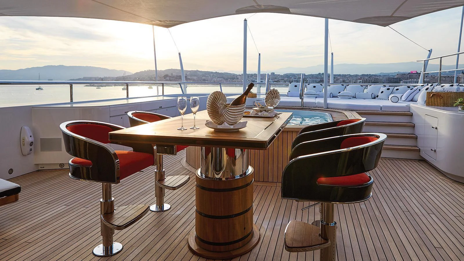 a table with chairs and a couple of glasses on it aboard MADAME KATE Yacht for Sale
