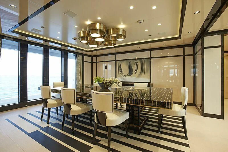 a large room with a table and chairs aboard MADAME KATE Yacht for Sale