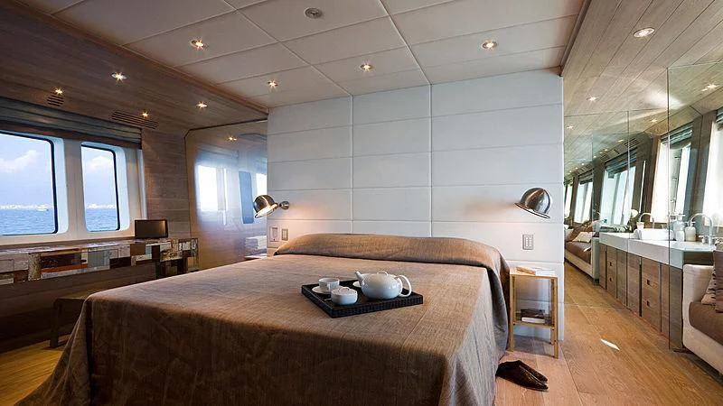 a bedroom with a bed and a desk aboard AHT Yacht for Sale