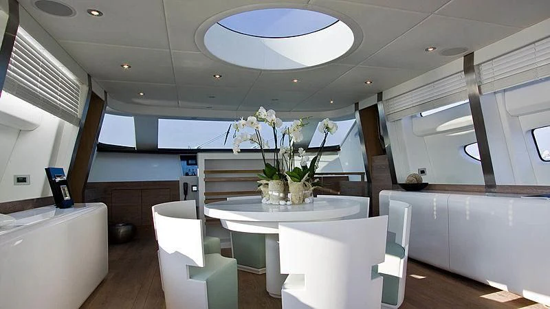 a room with a table and chairs aboard AHT Yacht for Sale