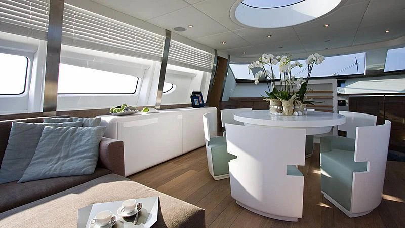 a living room with a white table and chairs aboard AHT Yacht for Sale