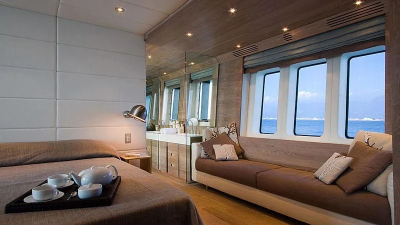 a room with a bed and a table aboard AHT Yacht for Sale