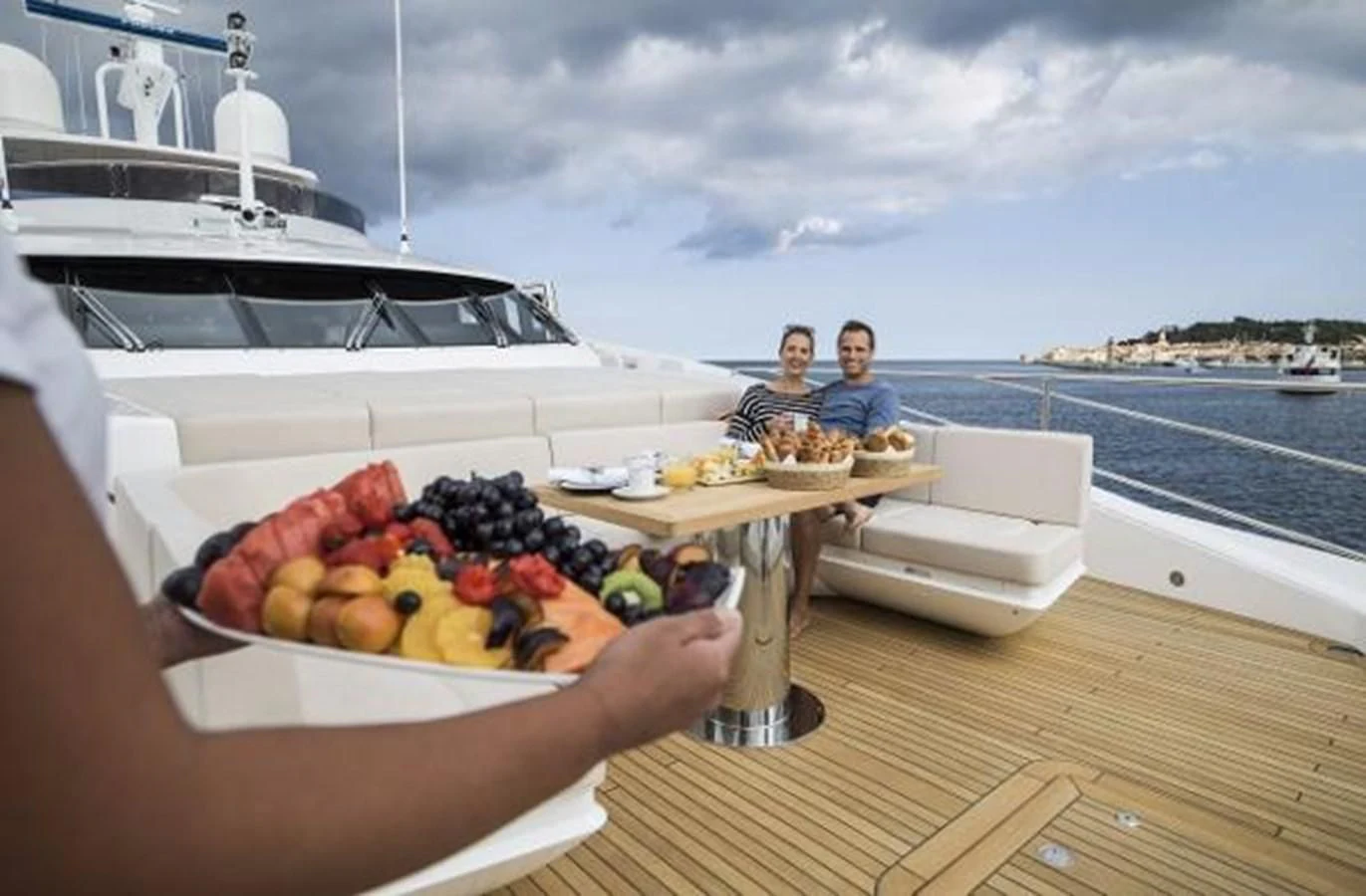 a couple of people sitting at a table with food on it aboard ZOZO Yacht for Sale