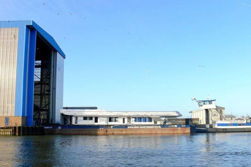 a building next to a body of water aboard EBONY SHINE Yacht for Sale