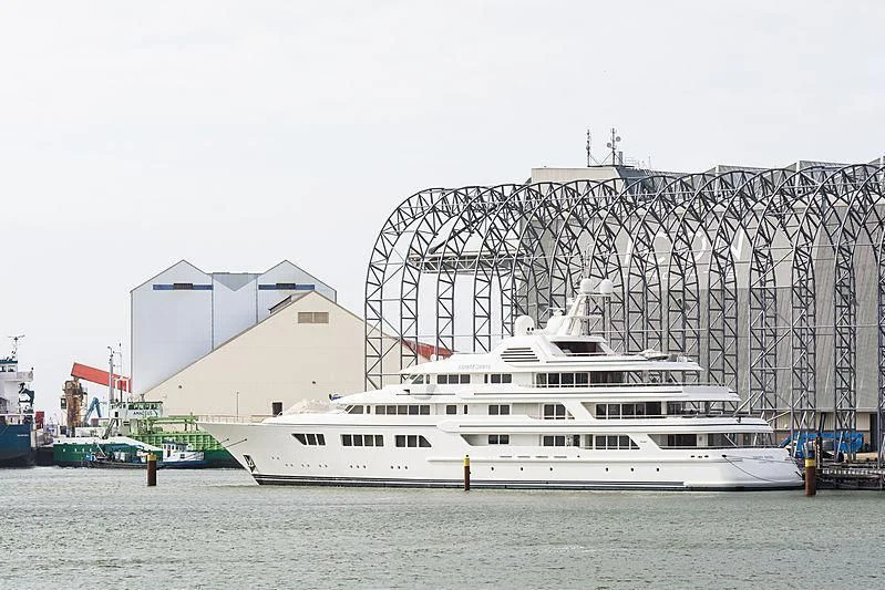 a large white boat in a harbor aboard EBONY SHINE Yacht for Sale