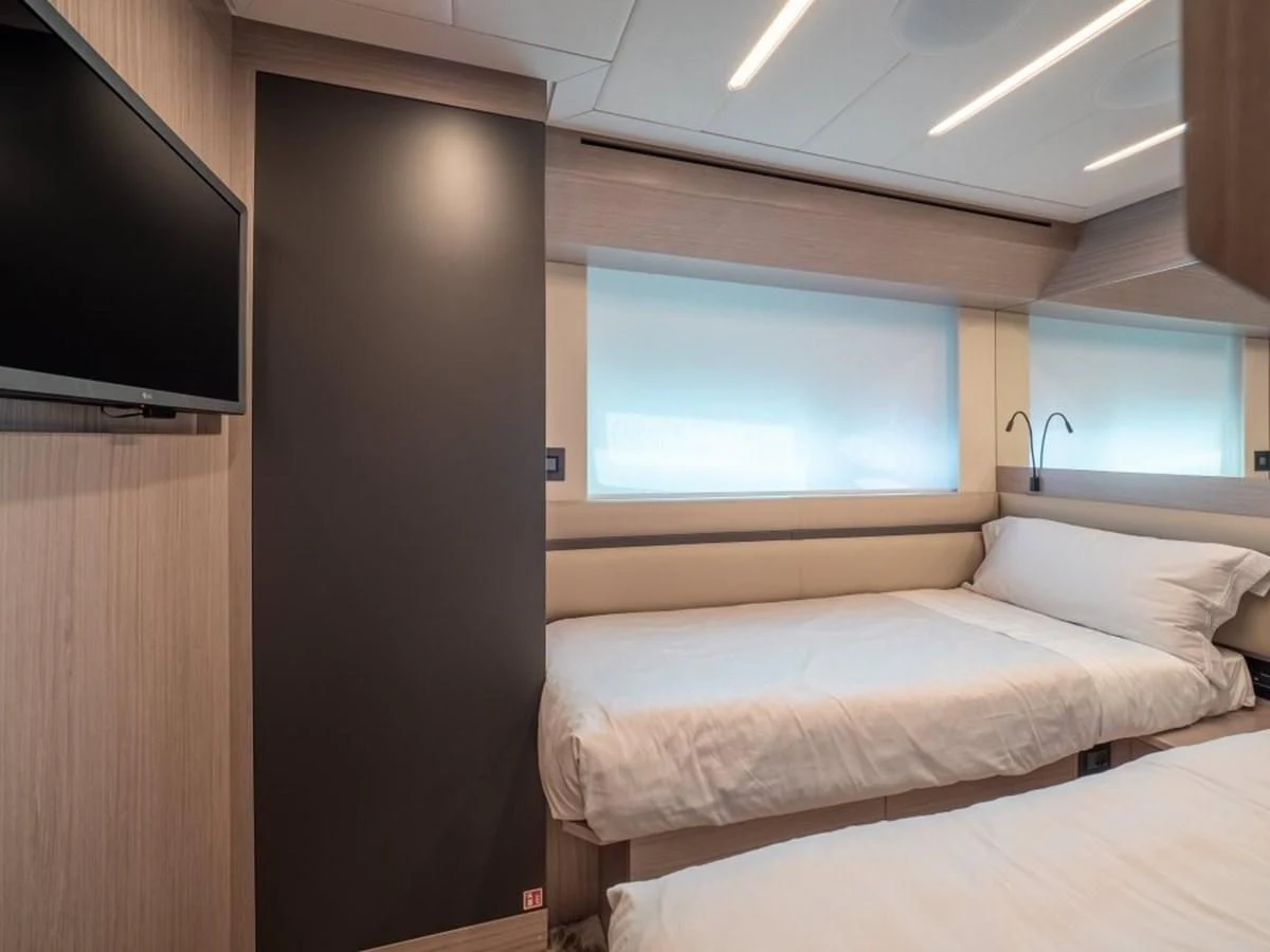 a room with a bed and a tv aboard SURVIVOR OF LONDON Yacht for Sale