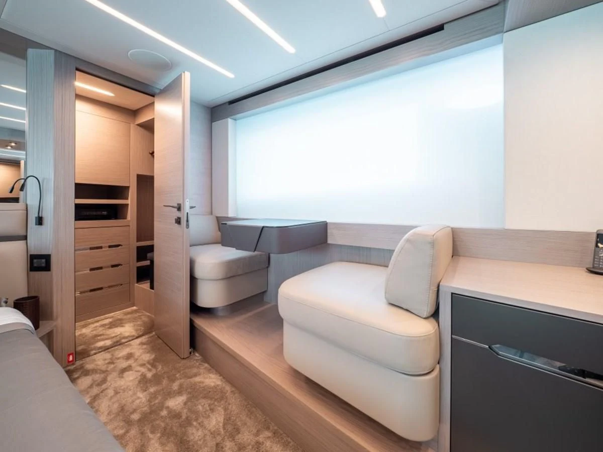 a room with a couch and a large window aboard SURVIVOR OF LONDON Yacht for Sale